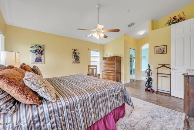 bedroom featuring ceiling fan and ensuite bath