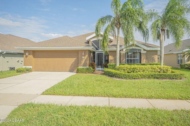 ranch-style house featuring a front lawn and a garage