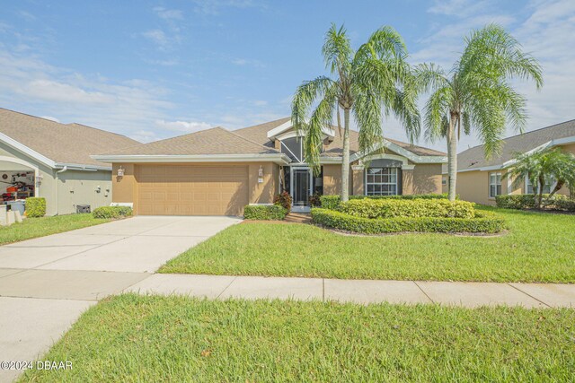 ranch-style house featuring a front lawn and a garage