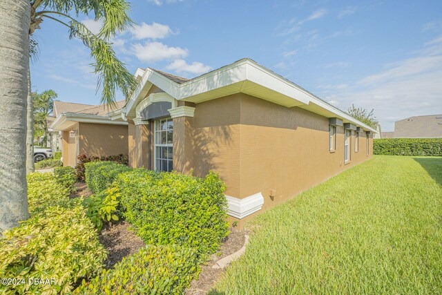 view of side of home featuring a yard