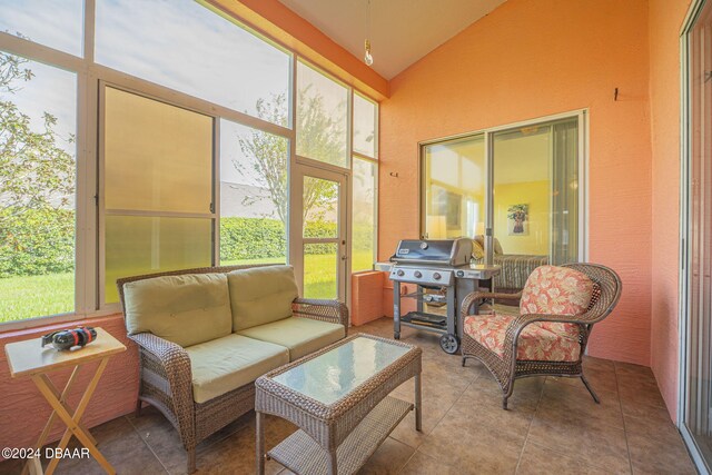 sunroom featuring a healthy amount of sunlight and vaulted ceiling