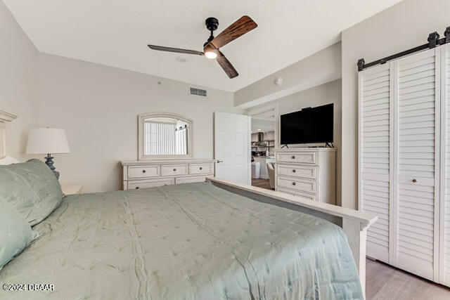 350 N Atlantic Ave Unit 2124, Daytona Beach, FL 32118 - bedroom with ceiling fan, a closet, and light wood-type flooring