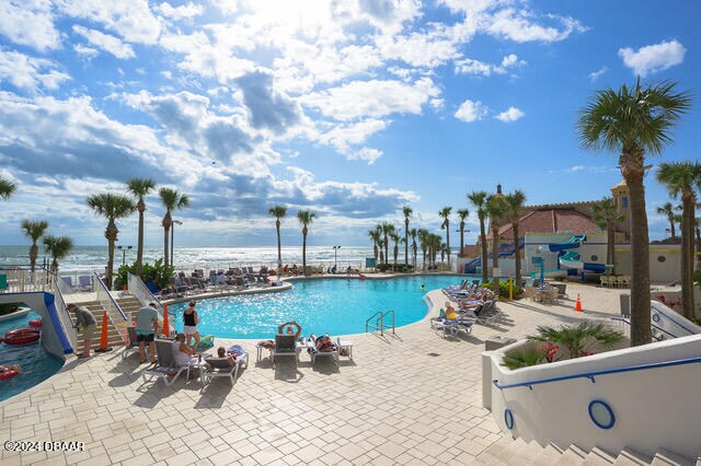 350 N Atlantic Ave Unit 2124, Daytona Beach, FL 32118 - view of pool with a water view and a patio