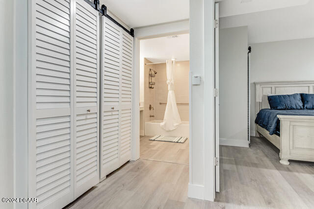 350 N Atlantic Ave Unit 2124, Daytona Beach, FL 32118 - bedroom featuring light hardwood / wood-style flooring