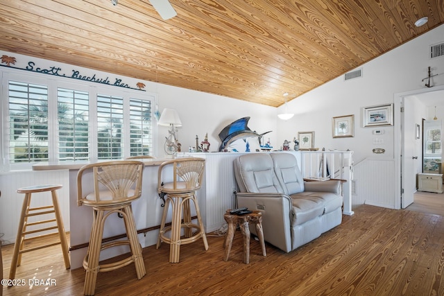 living area with hardwood / wood-style floors, vaulted ceiling, and wooden ceiling