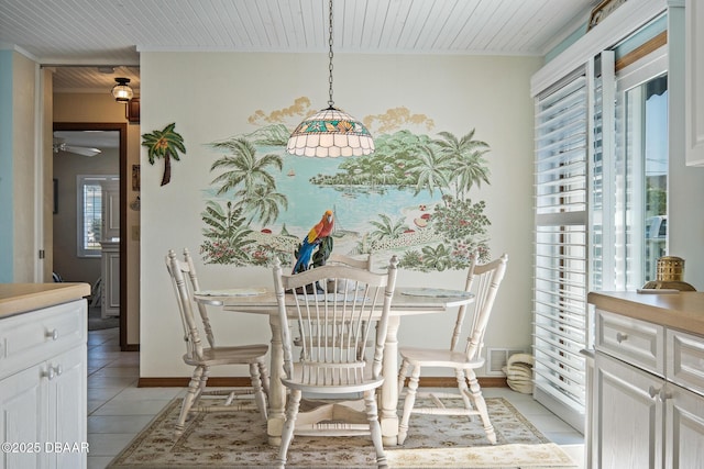 dining area featuring light tile patterned flooring and wooden ceiling