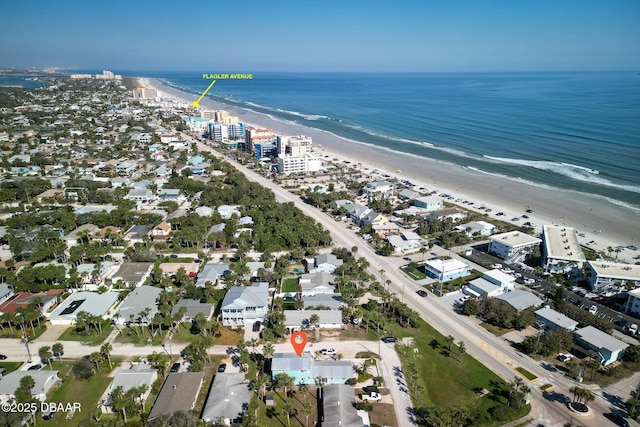 drone / aerial view featuring a beach view and a water view