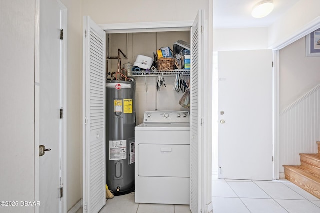 washroom featuring washer / dryer, water heater, and light tile patterned floors