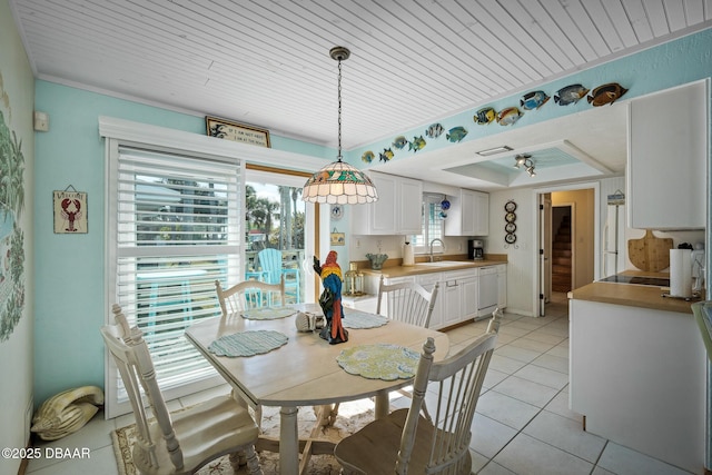 dining room featuring a tray ceiling, sink, light tile patterned floors, and wooden ceiling