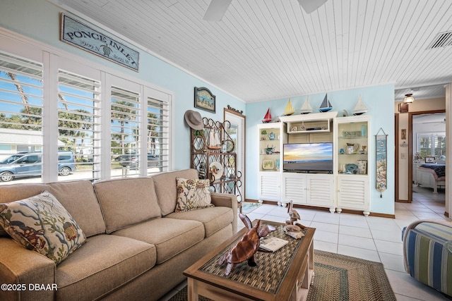 tiled living room featuring a healthy amount of sunlight, wood ceiling, and ceiling fan