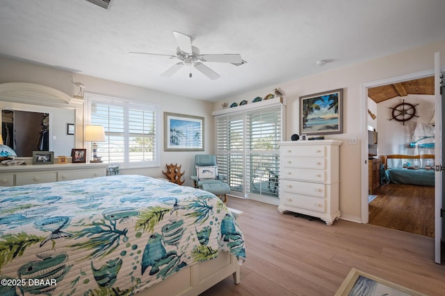 bedroom featuring ceiling fan, light hardwood / wood-style flooring, and access to outside