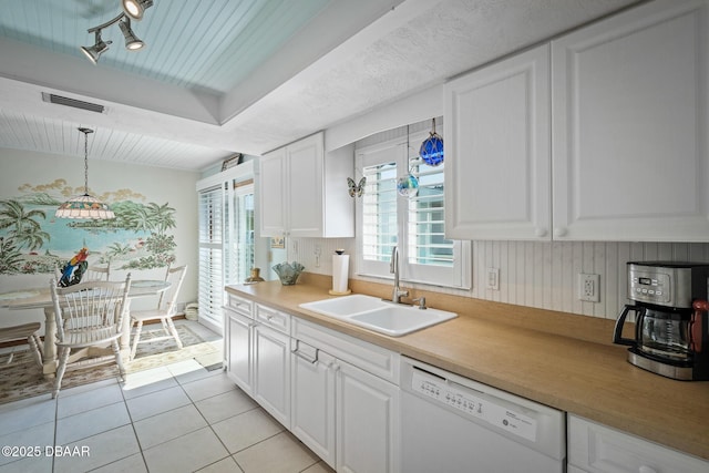 kitchen featuring white cabinetry, dishwasher, sink, and hanging light fixtures