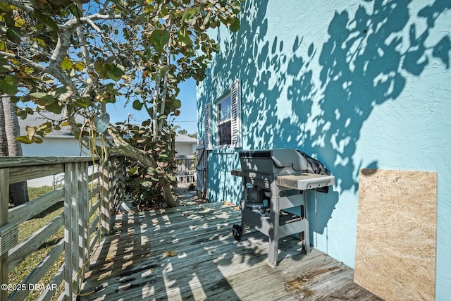 wooden deck featuring area for grilling