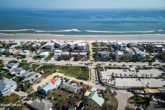 birds eye view of property featuring a water view and a view of the beach