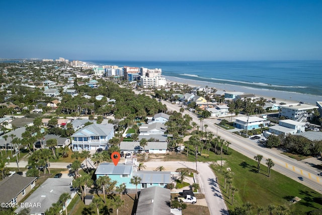 aerial view with a water view and a beach view