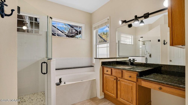 bathroom featuring separate shower and tub and vanity