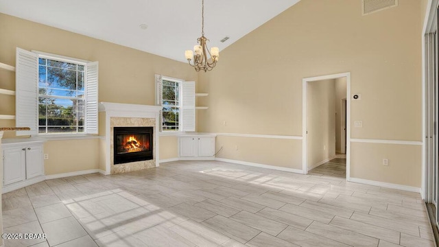 unfurnished living room with an inviting chandelier and vaulted ceiling