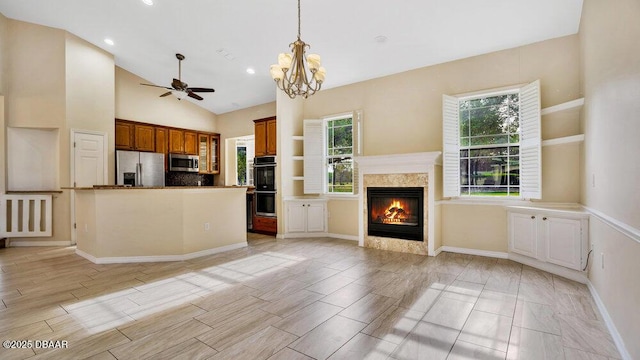 kitchen featuring tasteful backsplash, a healthy amount of sunlight, stainless steel appliances, and vaulted ceiling