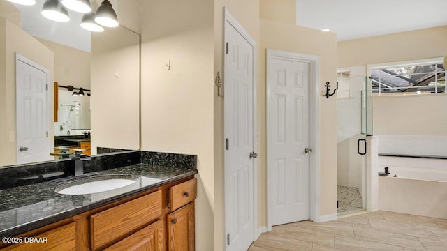 bathroom with vanity and separate shower and tub