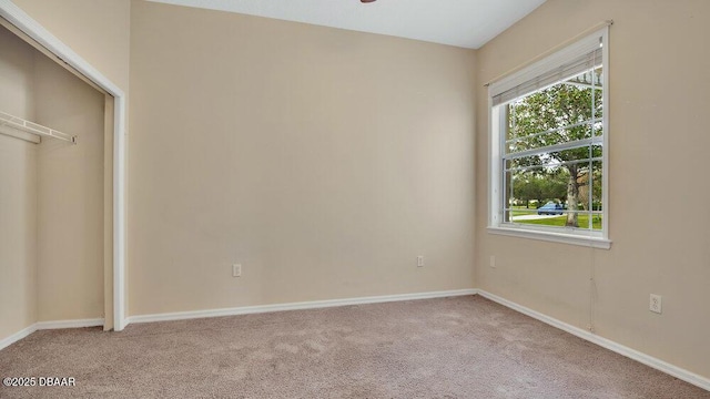 unfurnished bedroom featuring light carpet