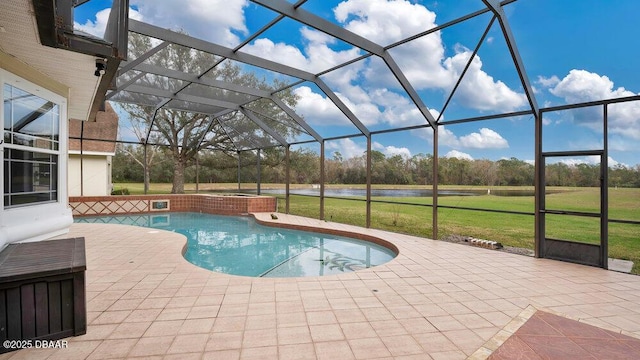 view of pool with a lawn, glass enclosure, and a patio