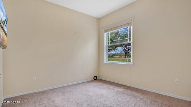 spare room with light colored carpet