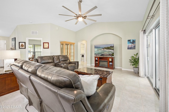 118 Bird Of Paradise Dr, Palm Coast, FL 32137 - living room with a ceiling fan, lofted ceiling, arched walkways, and light tile patterned floors