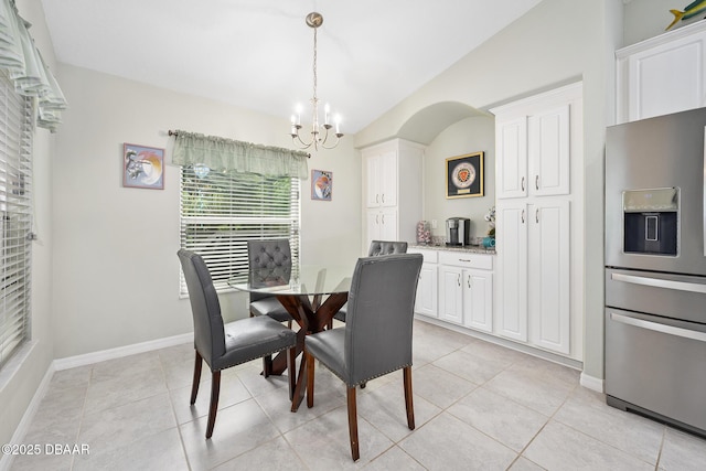 118 Bird Of Paradise Dr, Palm Coast, FL 32137 - dining room featuring a chandelier, lofted ceiling, and light tile patterned floors