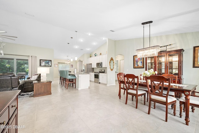 118 Bird Of Paradise Dr, Palm Coast, FL 32137 - dining room featuring a chandelier, light tile patterned flooring, and high vaulted ceiling