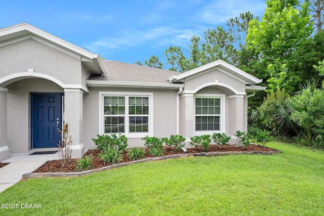 118 Bird Of Paradise Dr, Palm Coast, FL 32137 - single story home featuring a front lawn, stucco siding, and a shingled roof