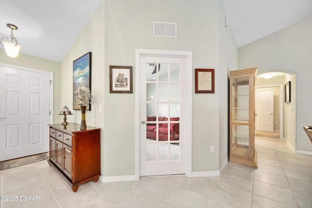 118 Bird Of Paradise Dr, Palm Coast, FL 32137 - foyer featuring arched walkways, light tile patterned floors, and high vaulted ceiling