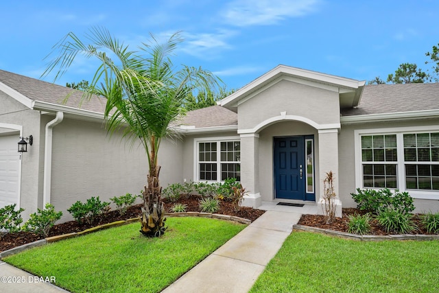 118 Bird Of Paradise Dr, Palm Coast, FL 32137 - entrance to property with a yard, stucco siding, and roof with shingles