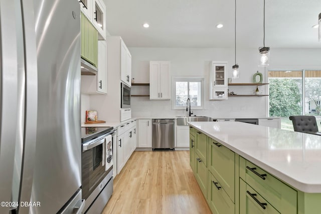 6 Willow Trce, Flagler Beach, FL 32136 - kitchen with green cabinetry, stainless steel appliances, a sink, healthy amount of natural light, and recessed lighting