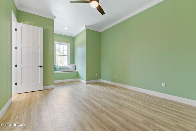 spare room with ceiling fan, light hardwood / wood-style flooring, and crown molding