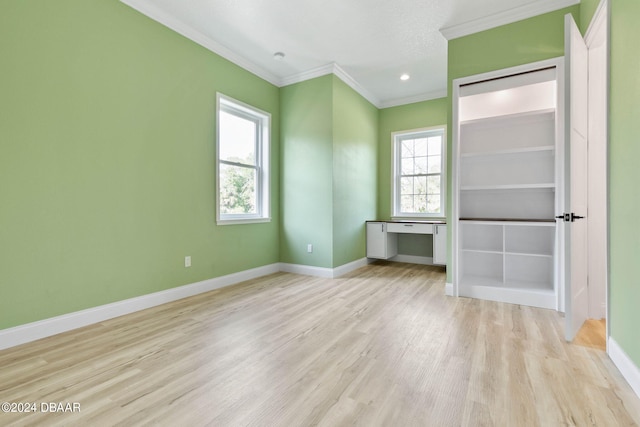 unfurnished bedroom featuring ornamental molding and light wood-type flooring