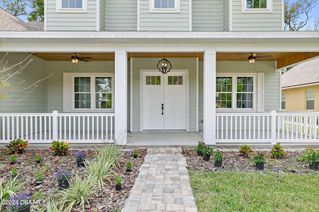 view of exterior entry with a porch and ceiling fan