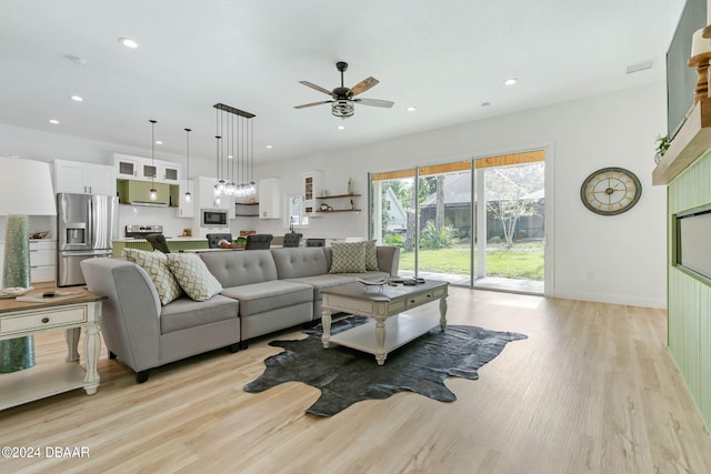 living room with light wood-type flooring and ceiling fan