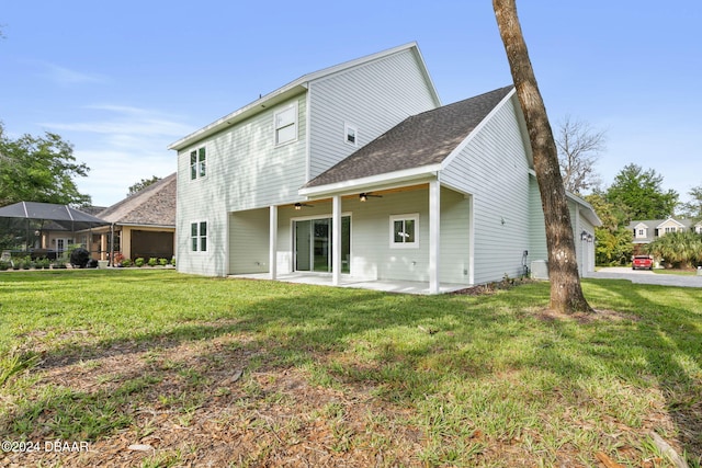 back of property featuring a lawn, a lanai, and a patio area