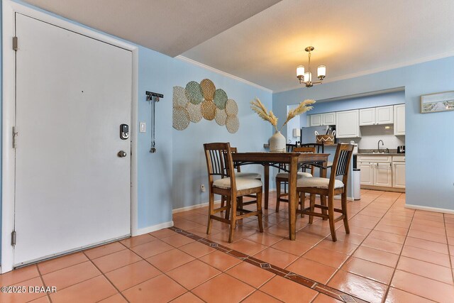 2800 N Atlantic Ave Unit 206, Daytona Beach, FL 32118 - dining area with light tile patterned flooring, a chandelier, ornamental molding, and baseboards