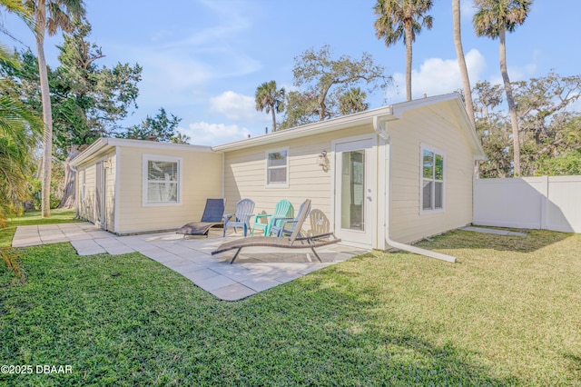 rear view of house featuring a patio area and a lawn