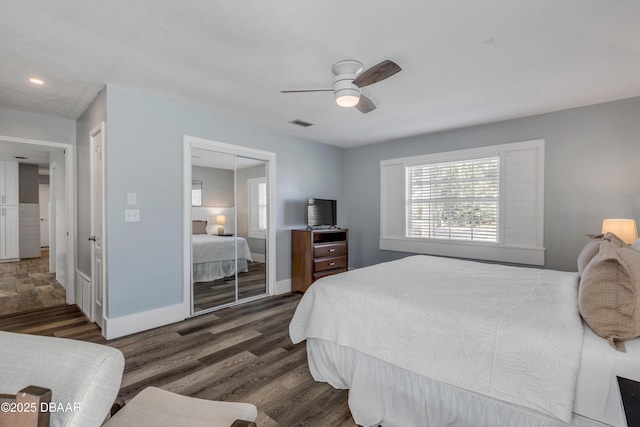 bedroom with ceiling fan, a closet, and dark wood-type flooring