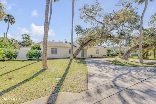 ranch-style home with a front lawn