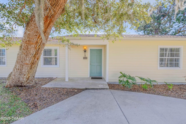 doorway to property with a patio area