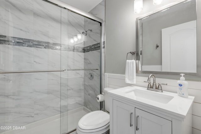 bathroom featuring toilet, vanity, and an enclosed shower