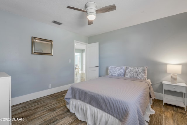 bedroom with ceiling fan and dark hardwood / wood-style floors