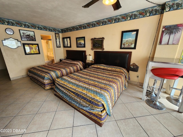 1233 S Atlantic Ave Unit 211, Daytona Beach, FL 32118 - bedroom with tile patterned flooring, a ceiling fan, and ensuite bathroom
