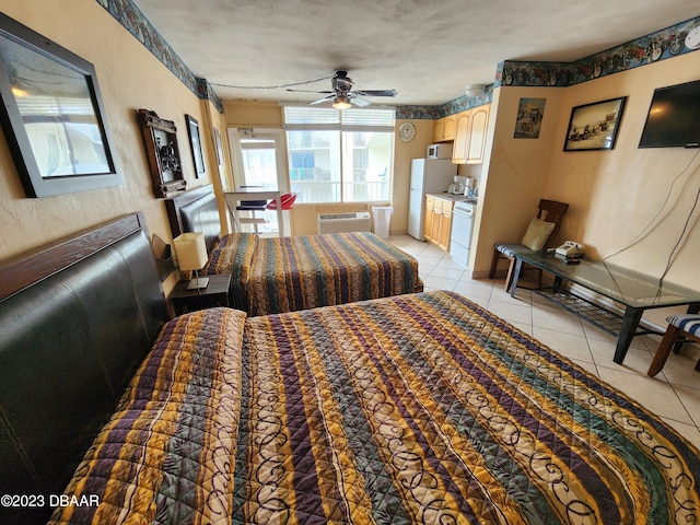 1233 S Atlantic Ave Unit 211, Daytona Beach, FL 32118 - bedroom featuring light tile patterned flooring, a wall mounted AC, and freestanding refrigerator
