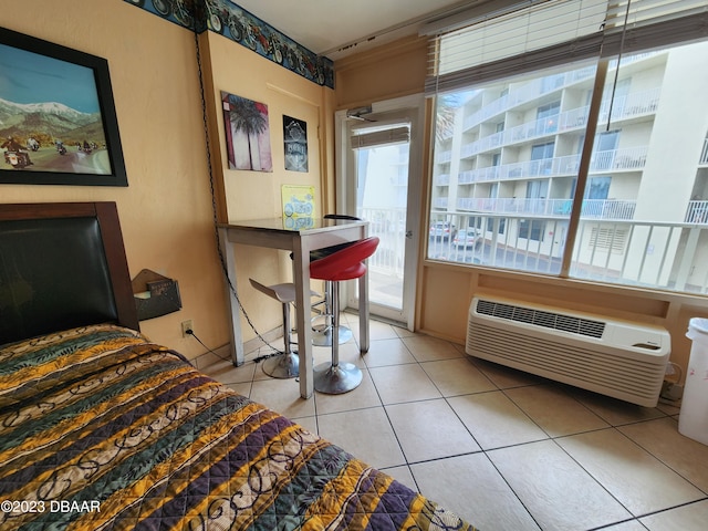 1233 S Atlantic Ave Unit 211, Daytona Beach, FL 32118 - bedroom featuring access to outside, light tile patterned floors, and an AC wall unit