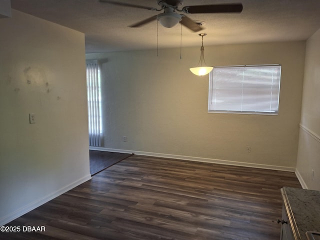 1031 NE 39th Ct, Ocala, FL 34470 - spare room with a ceiling fan and dark wood-style floors
