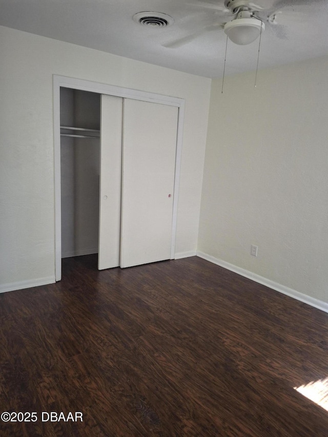 1031 NE 39th Ct, Ocala, FL 34470 - unfurnished bedroom with dark wood-type flooring, a closet, and a ceiling fan